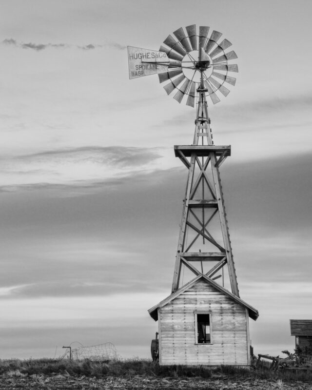A black and white photograph of old windmill in rural Douglas County, Washington.