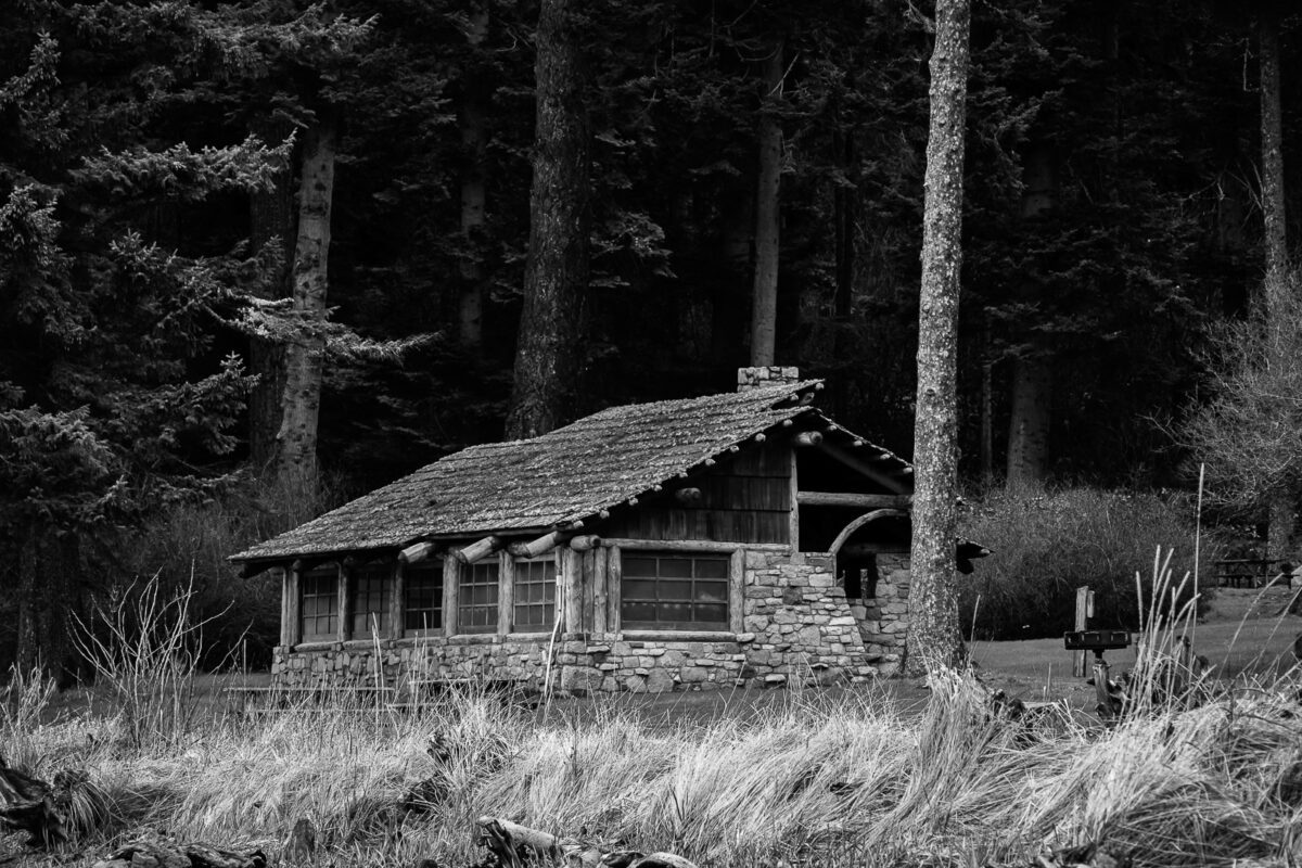 A black and white photograph of the Civilian Conservation Corps (CCC) picnic shelter on Bowman Bay at Deception Pass State Park, Fidalgo Island, Washington.