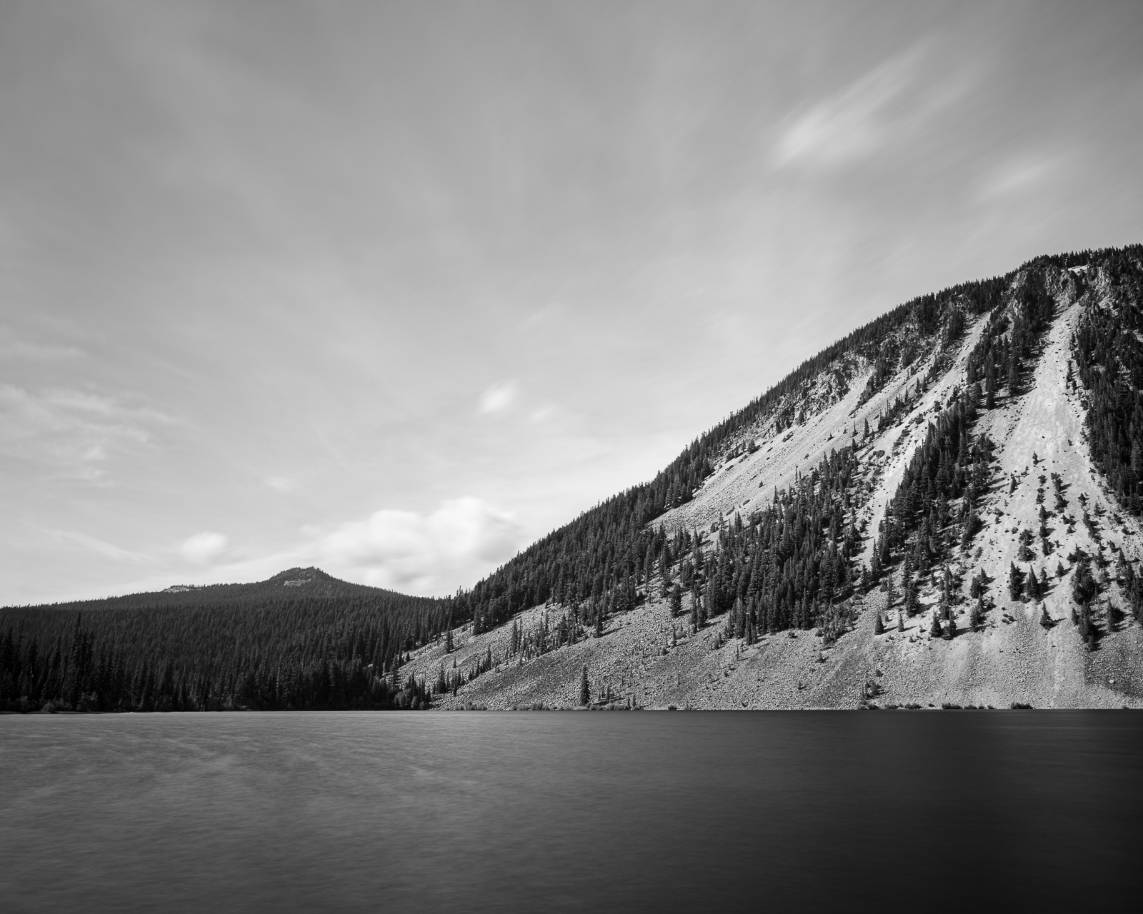 A long exposure black and white landscape photograph of Spiral Butte at Dog Lake near White Pass, Washington.