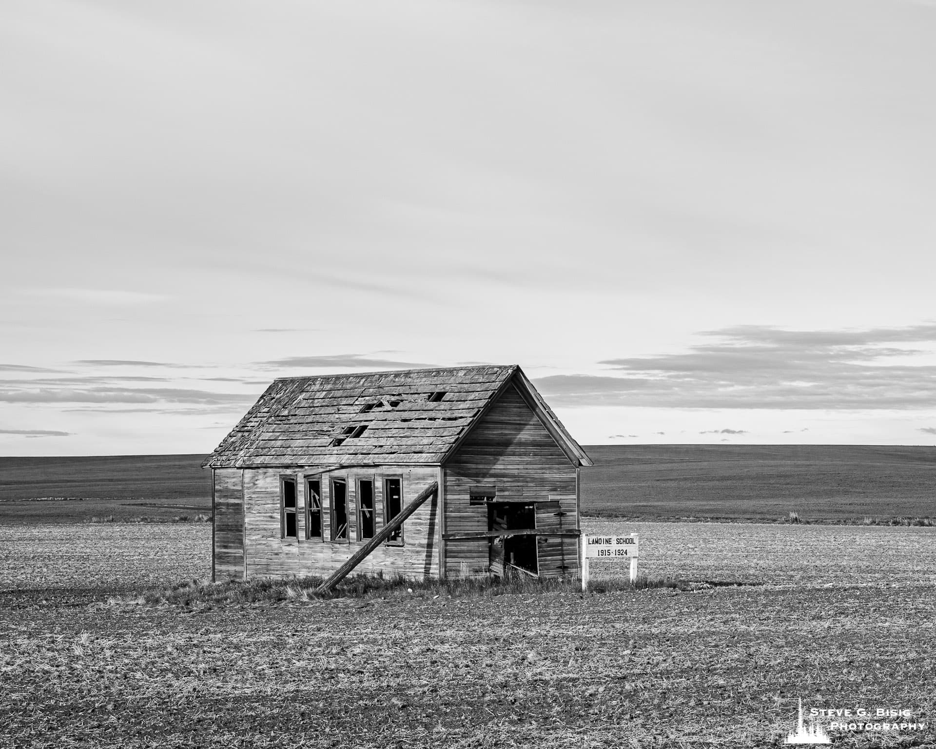 A black and white landscape photograph of the old Lamoine School House in Douglas County at Lamoine, Washington.