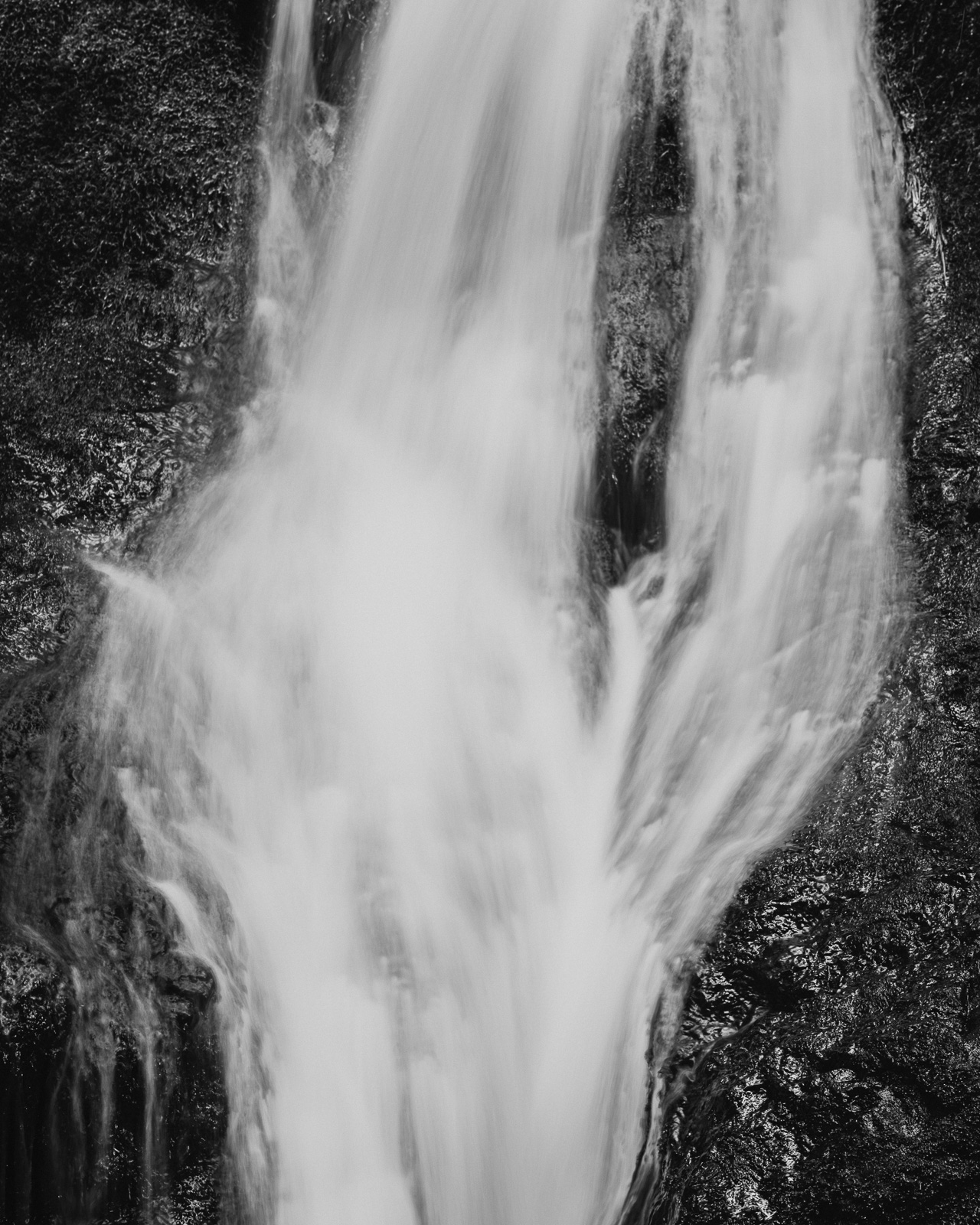 A closer view reveals the waterfall’s inner rhythm — water twisting and merging as it rushes over dark stone. In this fleeting pattern of motion and light, the creek reveals its quiet strength, shaped by gravity, time, and persistence.